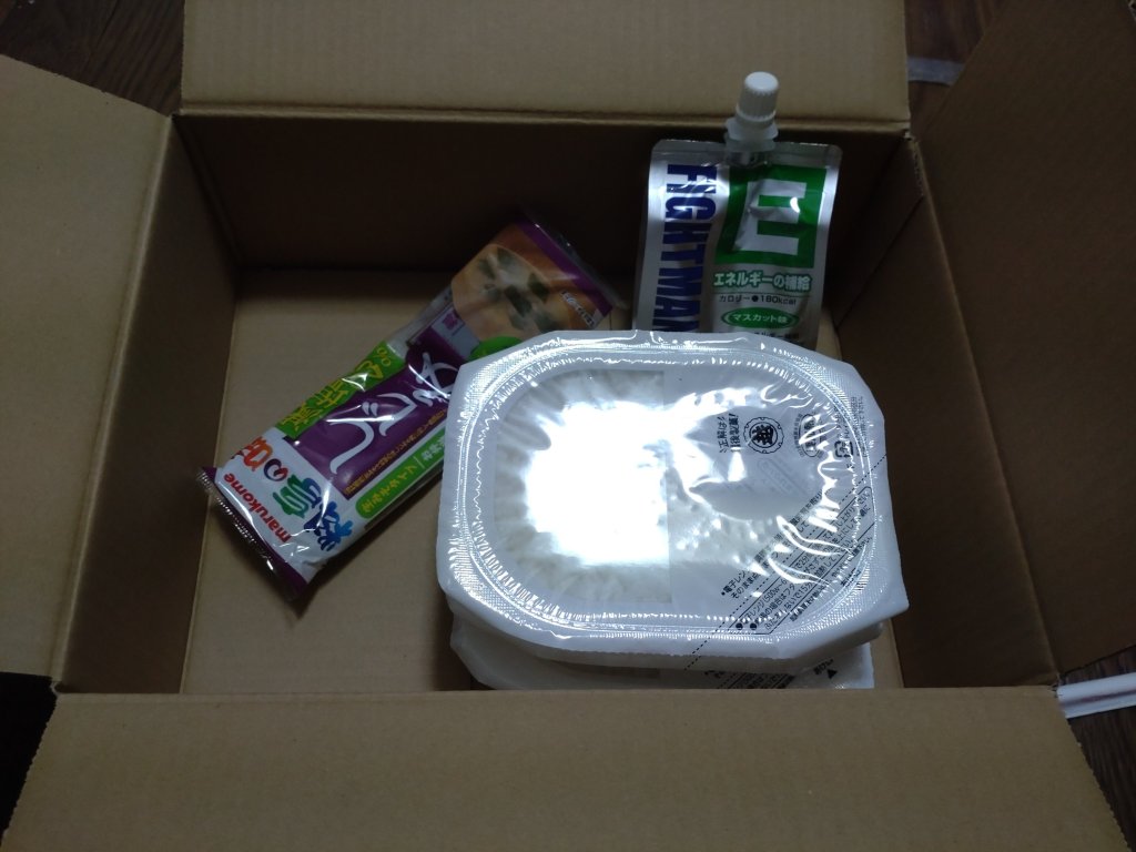 The first box from food assistance that is supposed to be one day of food: three packs of rice, miso soup paste, and vitamin enriched jelly.